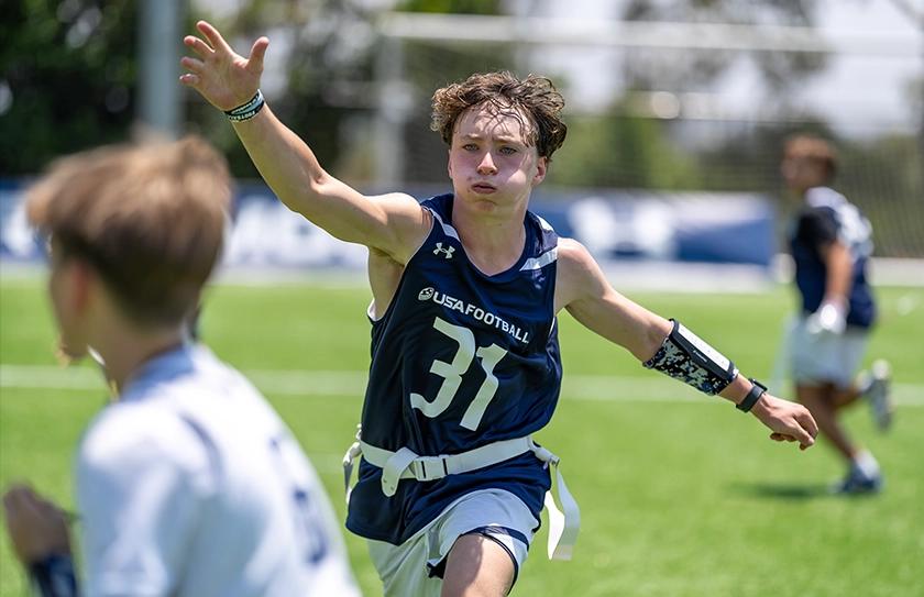 Boy Select Bowl athlete rushing the pass during tournament competition.