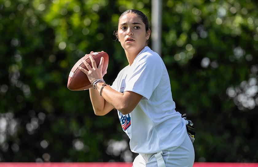 Girl Select Team athlete dropping back for a pass during quarterback testing at the Select Bowl.