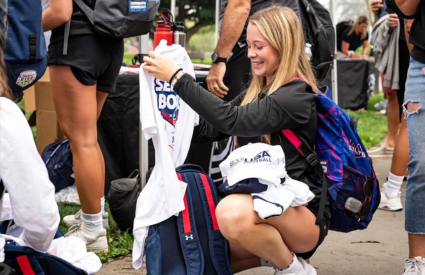 Girl Select Bowl athlete smiling after receiving USA Football Swag and Under Armour gear.